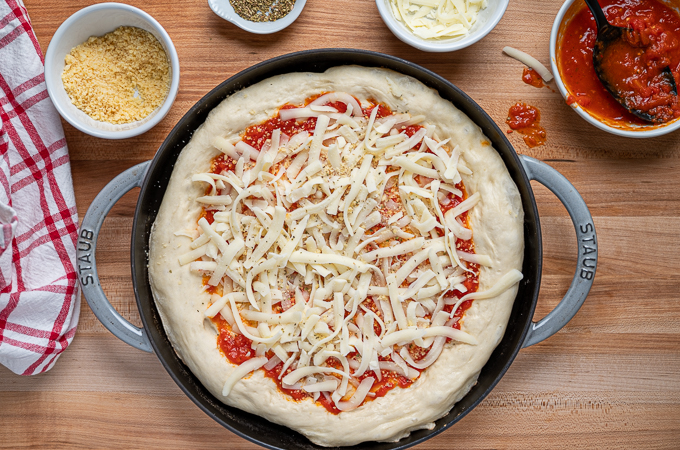 cast iron skillet pizza with sauce and cheese